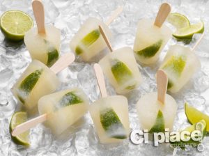 Tequila and lime ice lollies on a bed of ice cubes