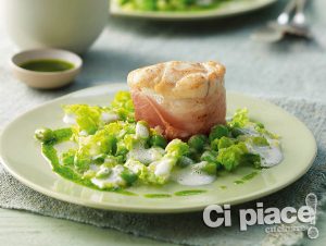 Monk fish tournedos in bacon with basil oil on green bean seeds and lettuce strips