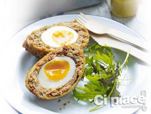 A Scotch egg with salad leaves