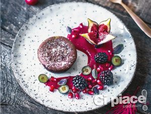 Chocolate cake with a liquid egg liqueur centre, raspberry sauce and autumn fruits
